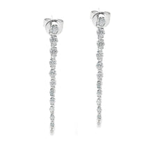 These 18k white gold diamond stick earrings feature 24 round brilli...