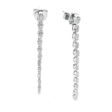 These 18k white gold diamond stick earrings feature 24 round brilli...