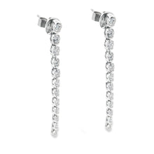 These 18k white gold diamond stick earrings feature 24 round brilli...