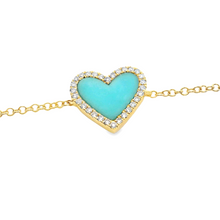 This bracelet features a heart shaped turquoise inlay with surround...