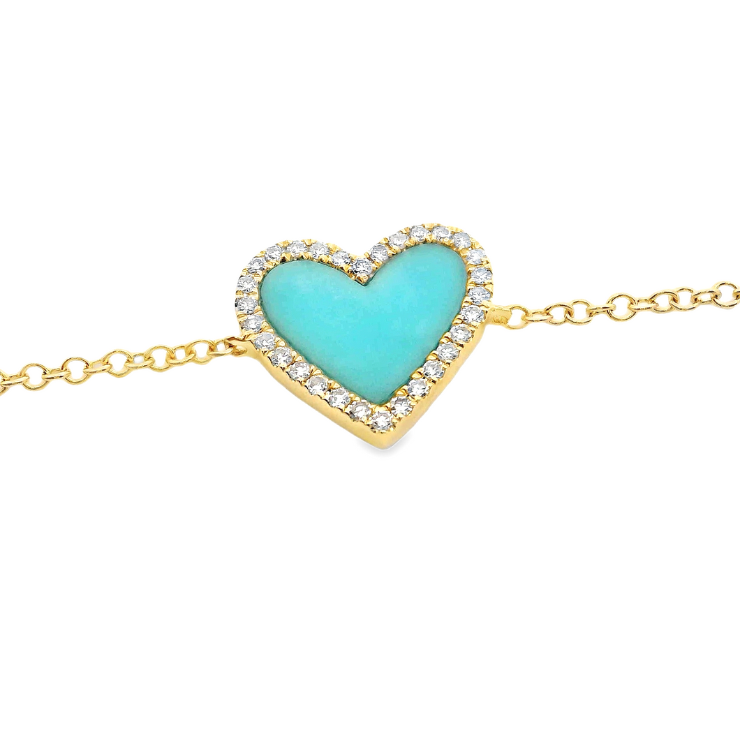 This bracelet features a heart shaped turquoise inlay with surround...