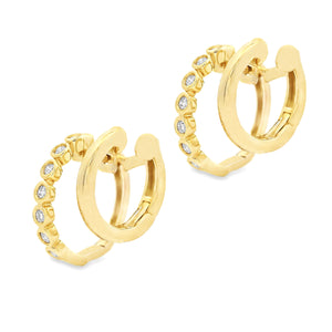 These small 14k yellow gold double hoop earrings feature bezel-set ...