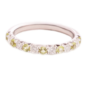 This 14k white gold band features alternating round brilliant cut d...