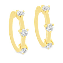 These stylish 14k yellow gold huggy earrings feature 6 round brilli...