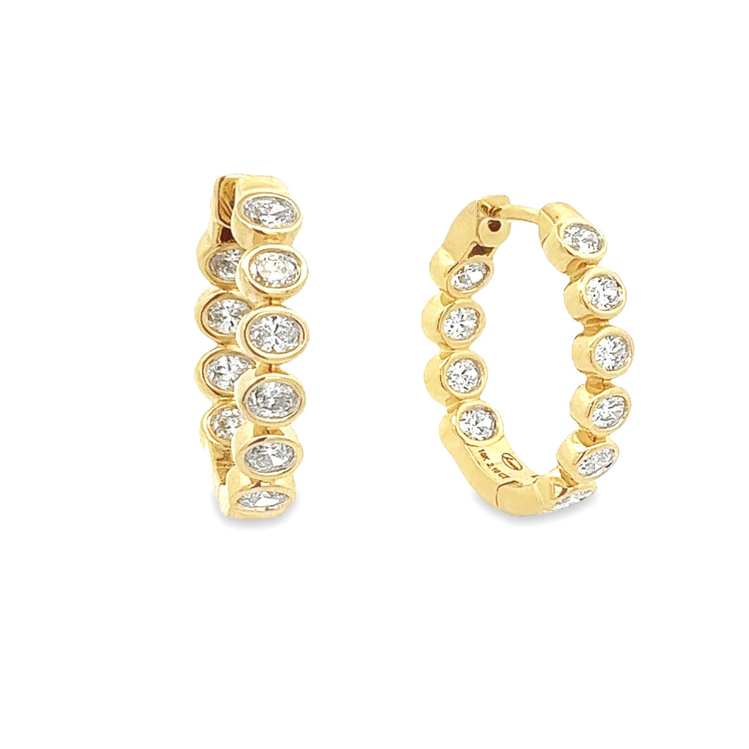 These beautiful 18k yellow gold diamond oval hoop earrings feature ...