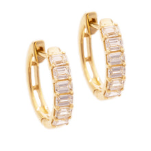 These 14k yellow gold huggy earrings feature 12 emerald cut diamond...