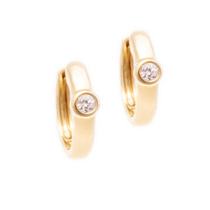 These 14k yellow gold huggy earrings feature 2 diamonds totaling ap...
