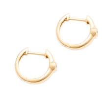 These 14k yellow gold huggy earrings feature 2 diamonds totaling ap...
