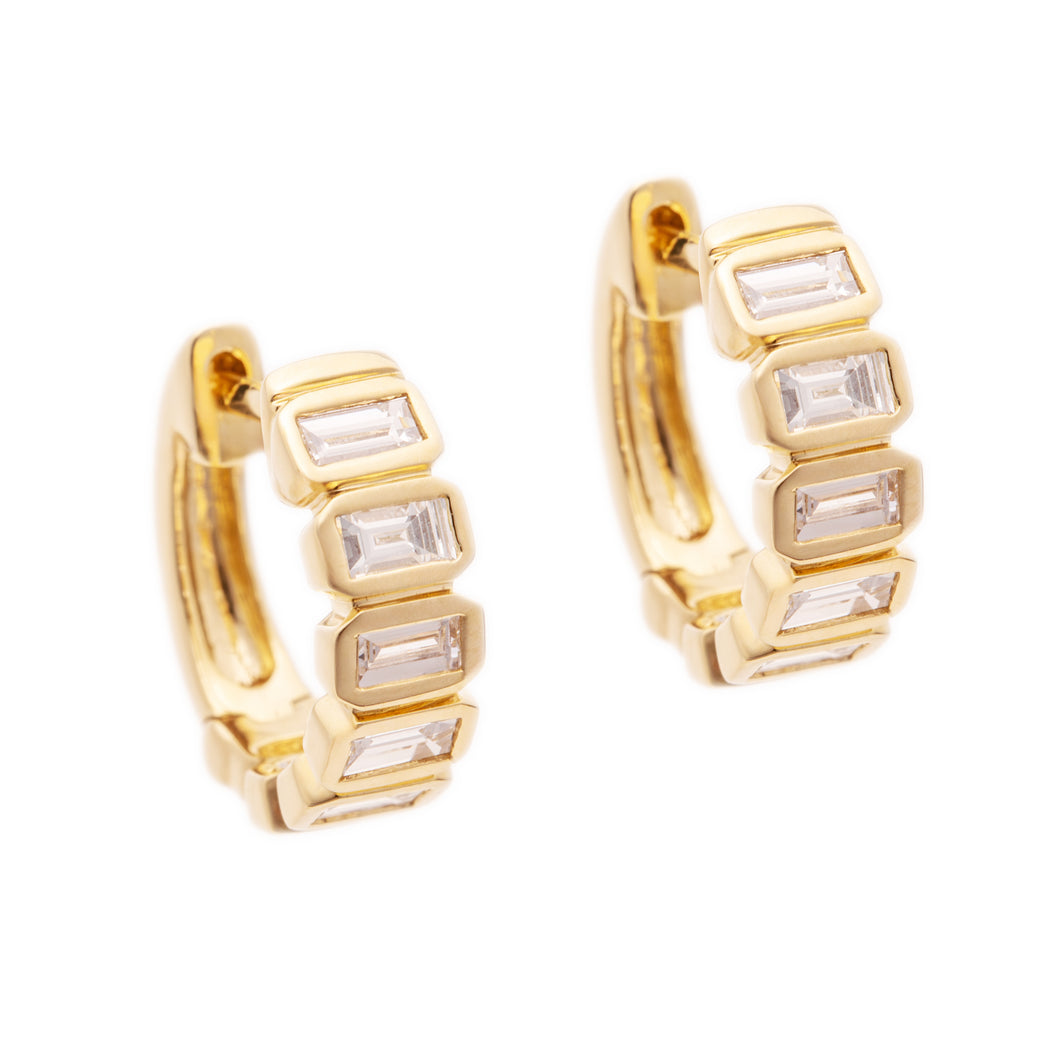 These 14k yellow gold huggy earrings feature baguette cut diamonds ...