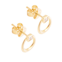 These 14k yellow gold stud circle earrings feature baguette cut dia...