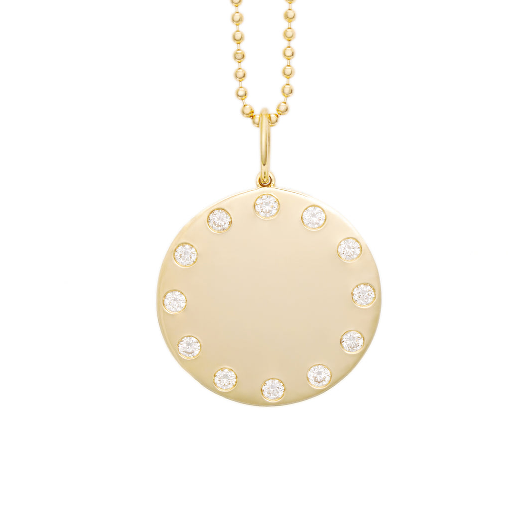 14k yellow gold disc pendant that features 12 round brilliant cut d...