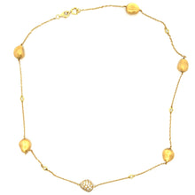 This 18k yellow gold necklace features pave set diamonds on the cen...