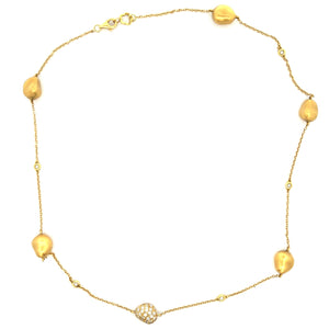 This 18k yellow gold necklace features pave set diamonds on the cen...