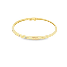 This easy to stack and style 14k yellow gold bangle features round ...