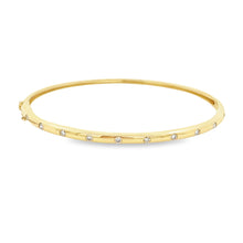 This easy to stack and style 14k yellow gold bangle features round ...