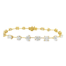 This stunning 18k yellow gold bracelet features various shapes of d...