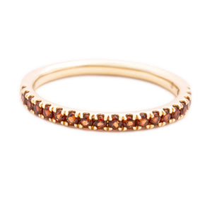 This 14k yellow gold band features garnet stones that wrap half way...