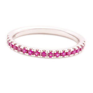 This 14k white gold band features ruby stones that wrap half way ar...