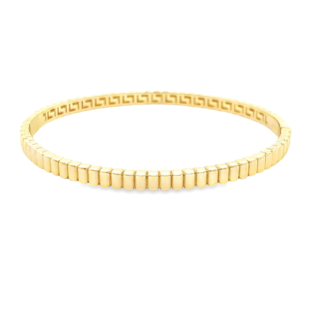 This 14k yellow gold bangle is ribbed around the whole bangle.