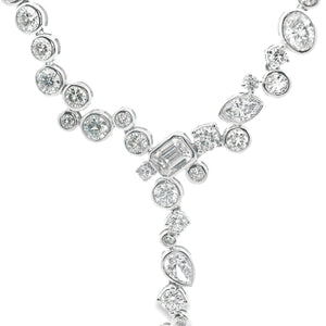 This beautiful 14k white gold diamond necklace features various sha...