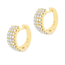 These small 14k yellow gold huggy earrings feature round brilliant ...