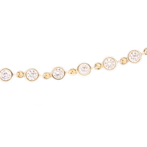 This easy to style 14k yellow gold bracelet features bezel set diam...