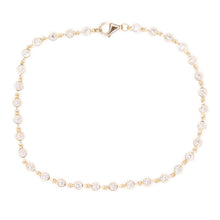 This easy to style 14k yellow gold bracelet features bezel set diam...