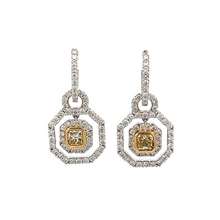 These 18k white gold earrings feature two  square radiant fancy yel...