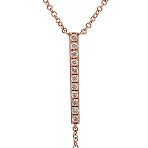 This lariat necklace features 11 round brilliant cut diamonds total...