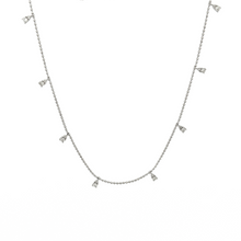 This dainty 14k white gold necklace features diamond drops that tot...