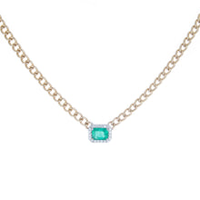 necklace features center emerald totaling .87ct and surround diamon...