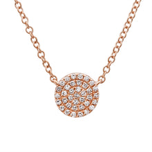 This necklace features a gold disc with a .10ct round brilliant cut...