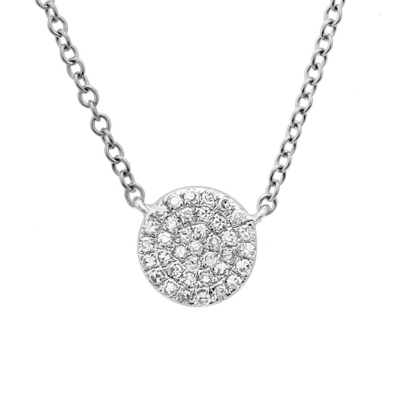 This necklace features a gold disc with a .10ct round brilliant cut...