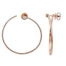 These hoop earrings feature pave set round brilliant cut diamonds t...