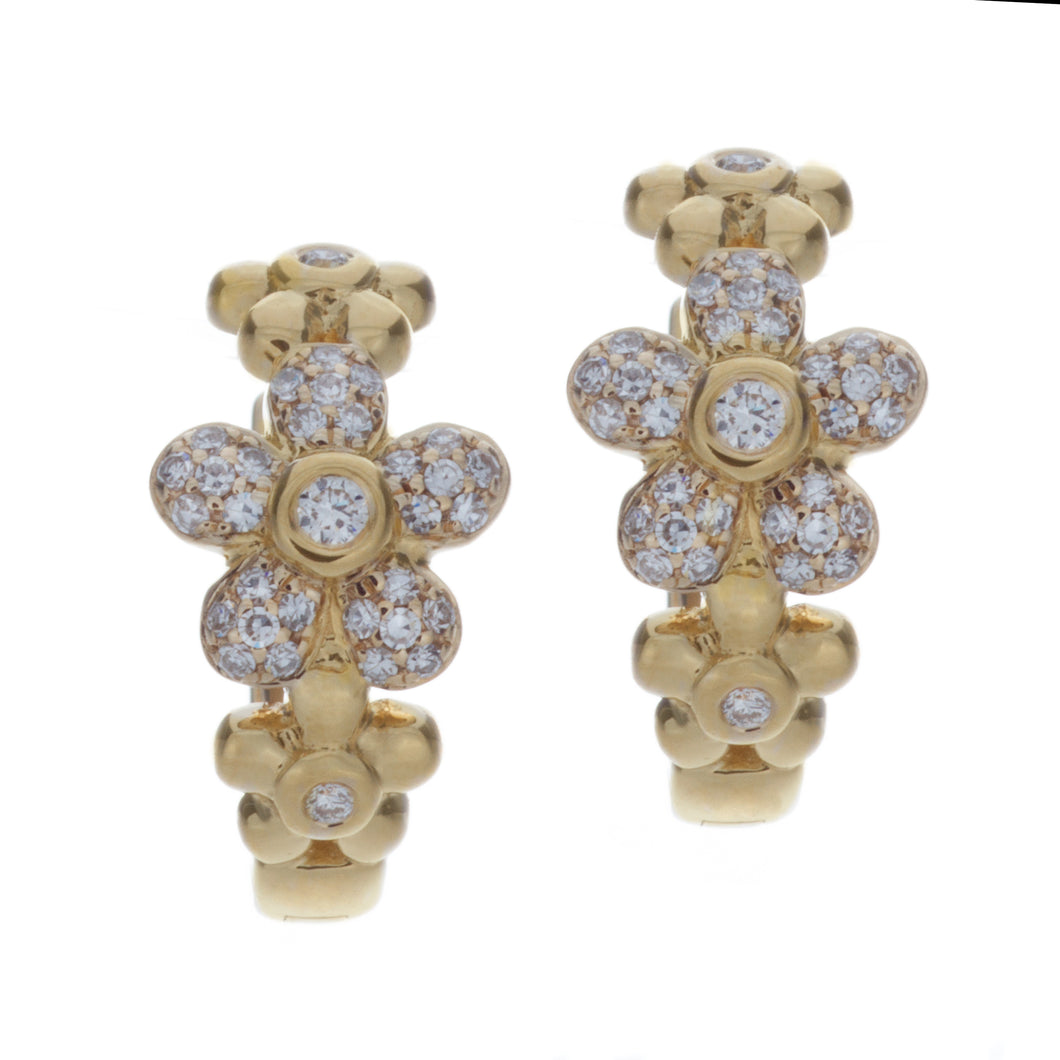 these small huggy hoops feature diamonds arranged in flower shapes ...