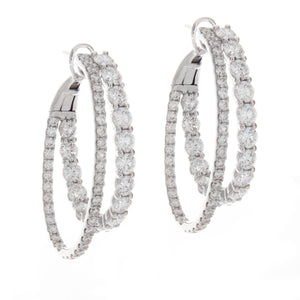 features 108 round brilliant cut diamonds arranged on double hoops,...