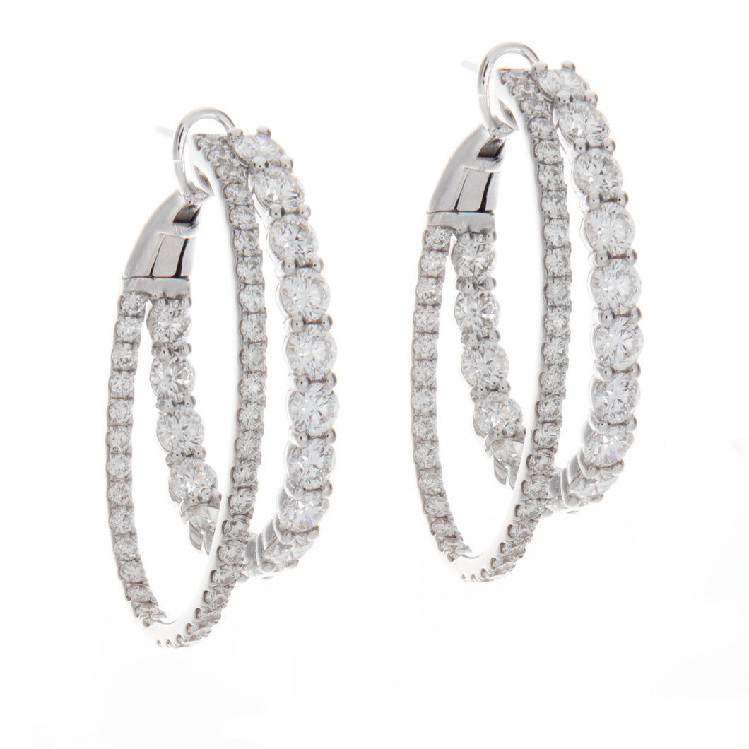 features 108 round brilliant cut diamonds arranged on double hoops,...
