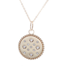 this disc pendant features 13 diamonds totaling .27ct