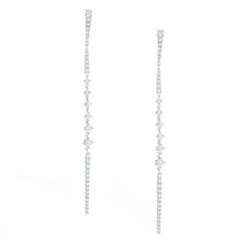 these skinny drop earrings taper down to a point and feature diamon...