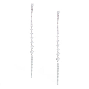 these skinny drop earrings taper down to a point and feature diamon...