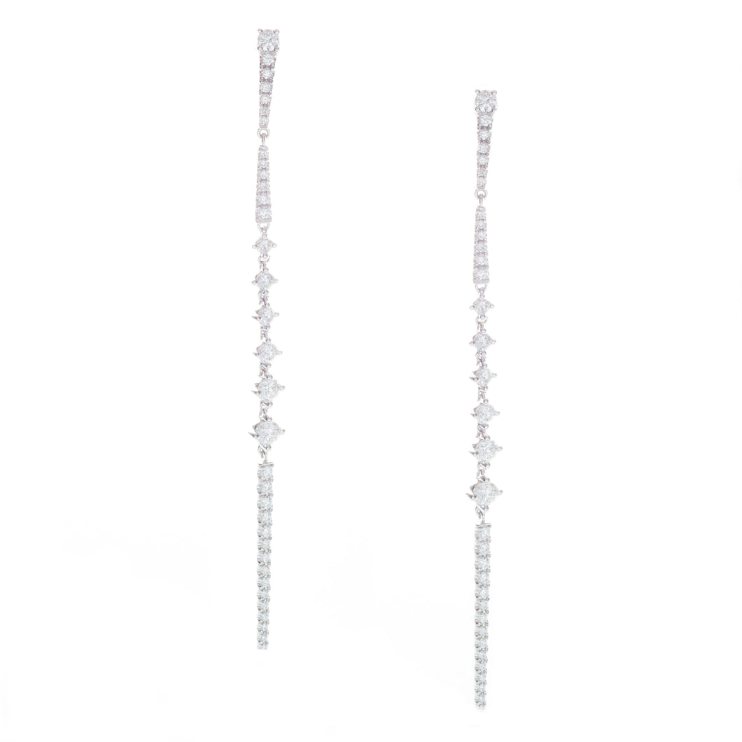 these skinny drop earrings taper down to a point and feature diamon...