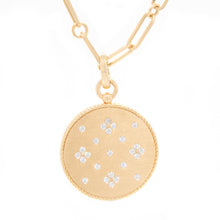 This 18k yellow gold link chain necklace features a gold disk penda...
