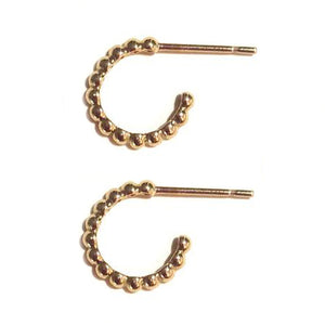 These diamond huggy earrings are in 14k yellow gold.