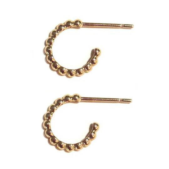 These diamond huggy earrings are in 14k yellow gold.