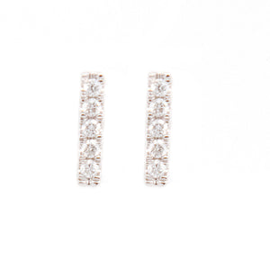 Simple and minimalist studs feature pave set diamonds totaling .06ct