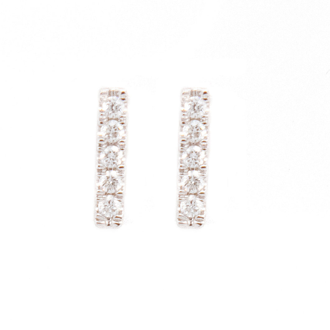 Simple and minimalist studs feature pave set diamonds totaling .06ct